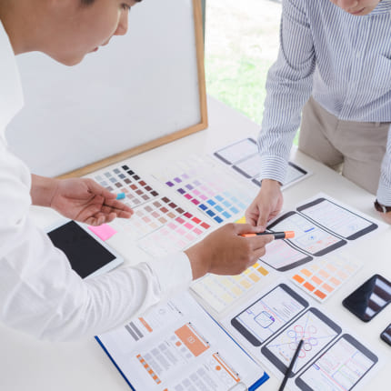 Mobile app development company experts discussing design ideas